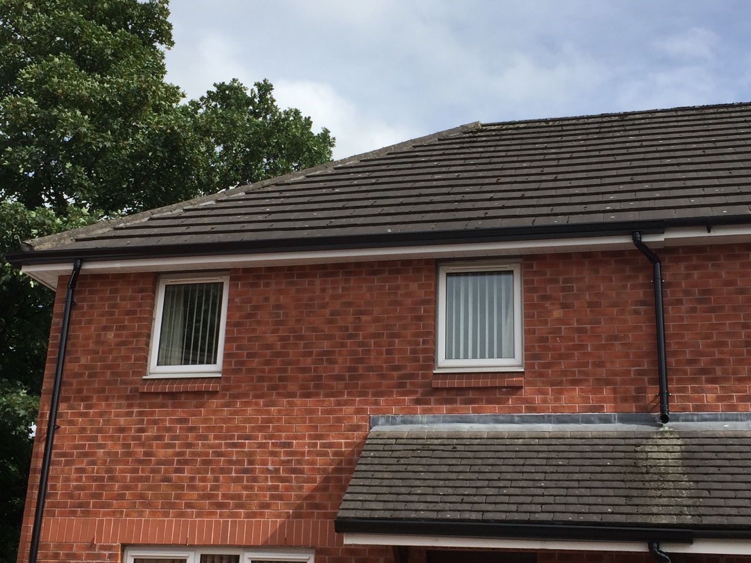 Completed black seamless guttering across the roofline